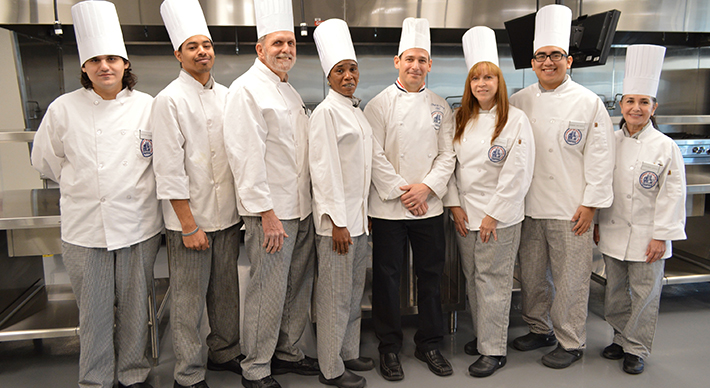 a group of chefs in a professional kitchen