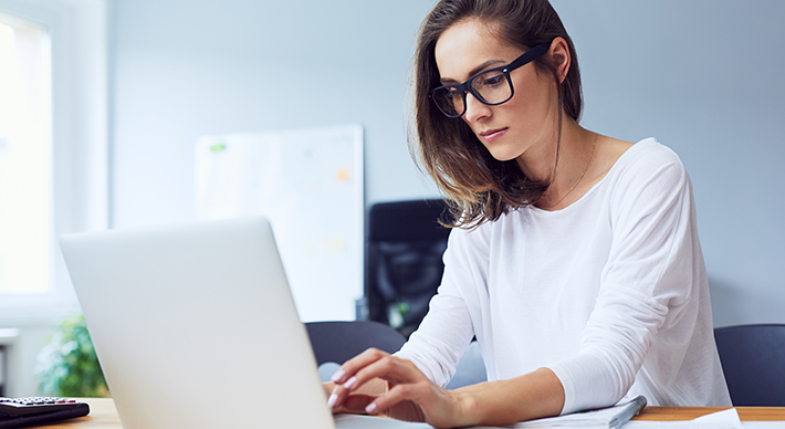a woman working at a laptop