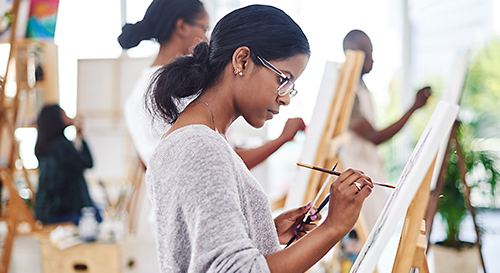 Women painting on canvas.